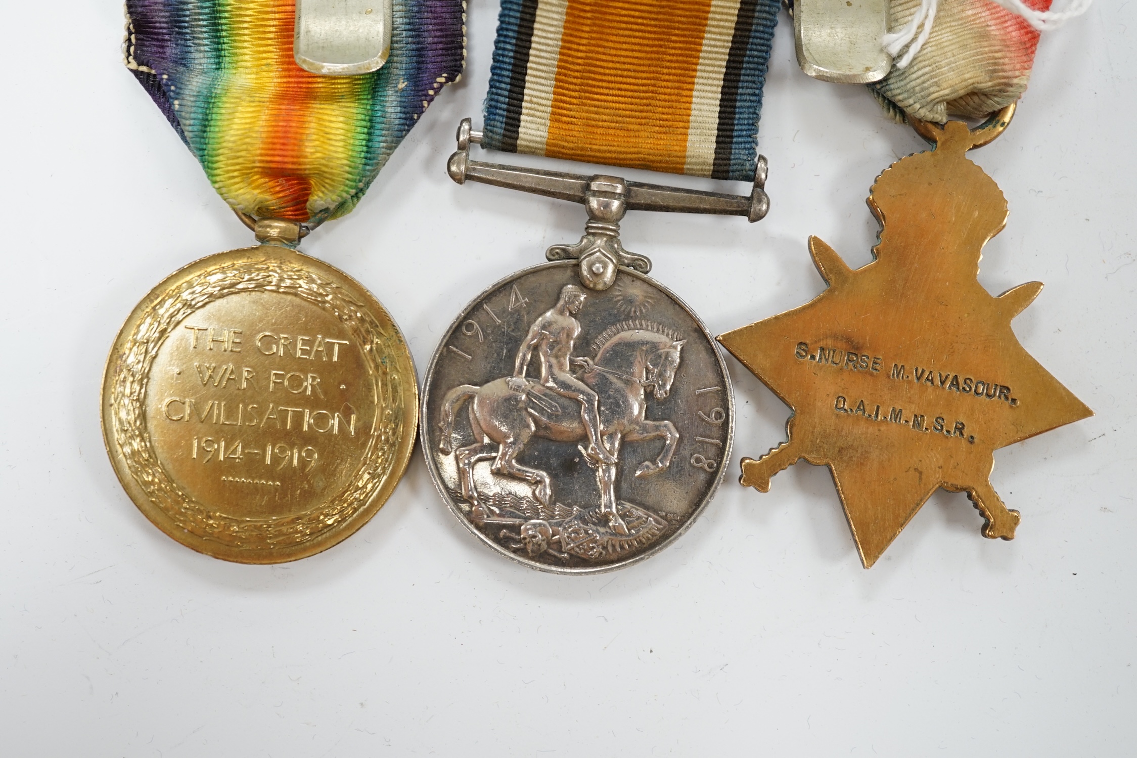 A First World War medal trio awarded to Staff Nurse M. Vavasour, Q.A.I.M.N.S.R. mounted together on a common pin. Condition - fair